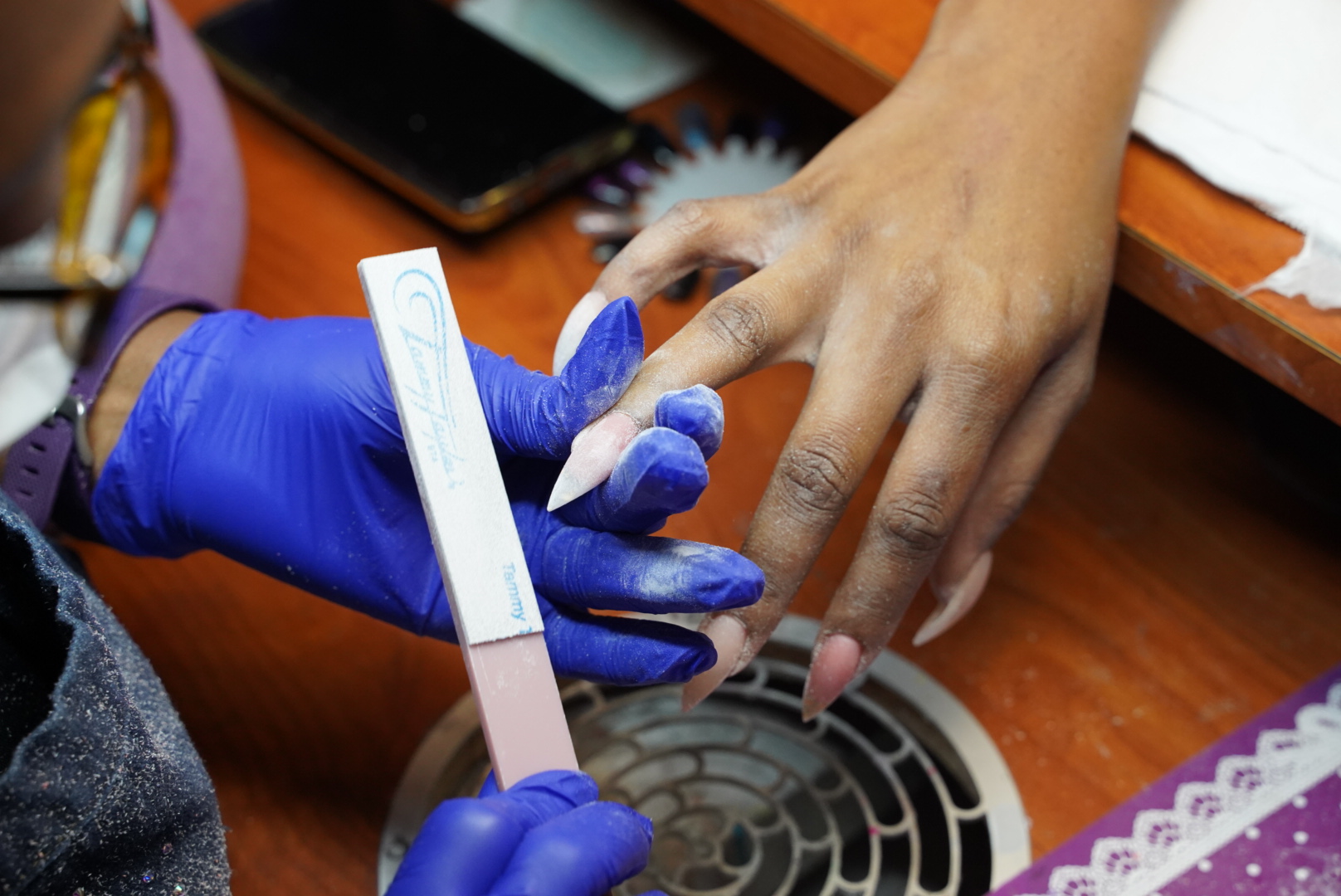 Chloe working on a client's nails in her San Antonio studio
