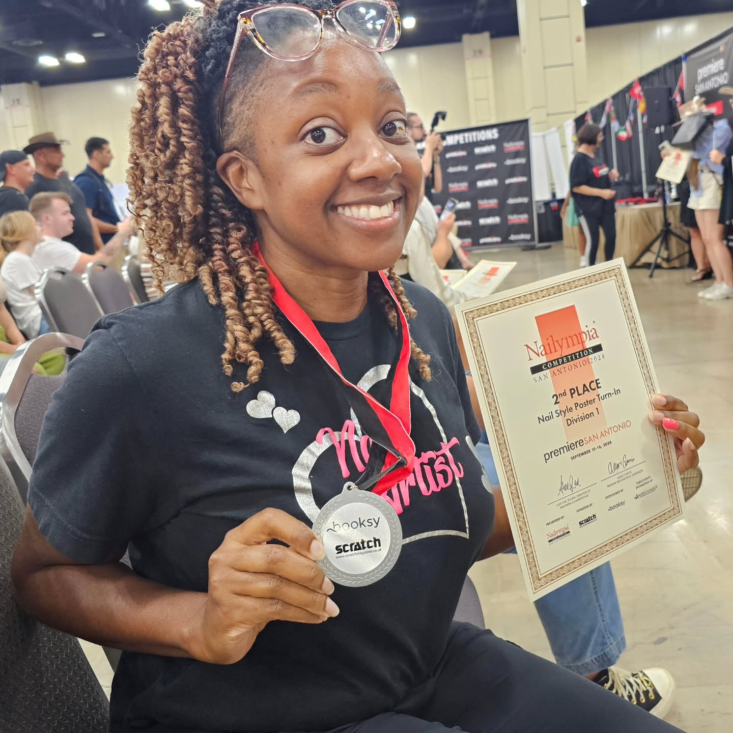 Chloe holding her Nailympia championship medal